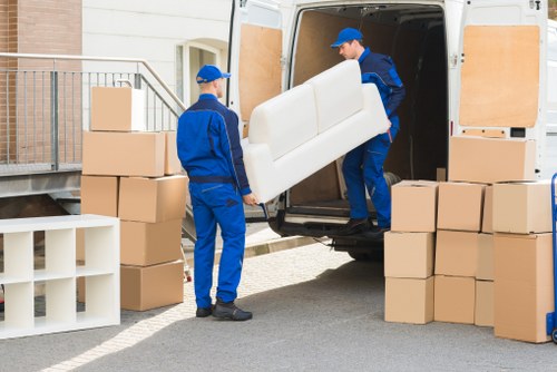 Professional movers loading household items for a Beckton move