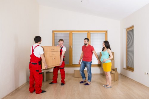 Loading boxes and household items into a van for a Beckton move