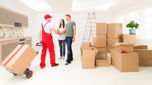 Local movers handling office equipment during a Beckton relocation