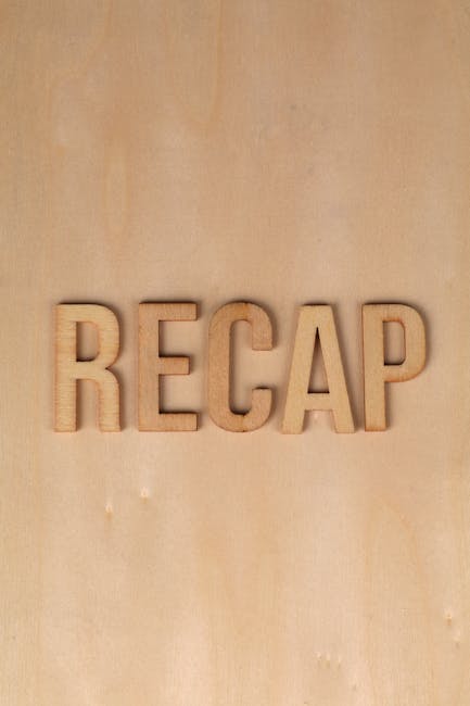 A close-up image of a light wooden wall with the word 'RECAP' spelled out in individual 3D wooden letters mounted on the surface. The letters are evenly spaced and have a natural wood finish, contrasting with the slightly textured background. This setting appears to be part of an indoor space, possibly a staging or review area related to house removals or moving services, such as those provided by Man with Van Beckton. The focus on 'RECAP' suggests documentation or review of a home relocation process, including furniture transport, packing, and moving logistics. The lighting is soft and natural, highlighting the texture of the wood, and the overall scene emphasizes professional and organized removal services, aligning with the theme of understanding quotes and planning for home moves.